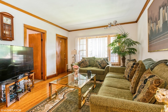 living room with crown molding and hardwood / wood-style flooring