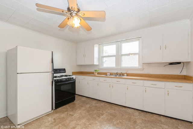 kitchen featuring black range with gas stovetop, sink, white cabinets, ornamental molding, and white refrigerator