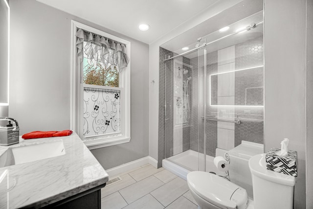 bathroom with tile patterned flooring, vanity, toilet, and walk in shower