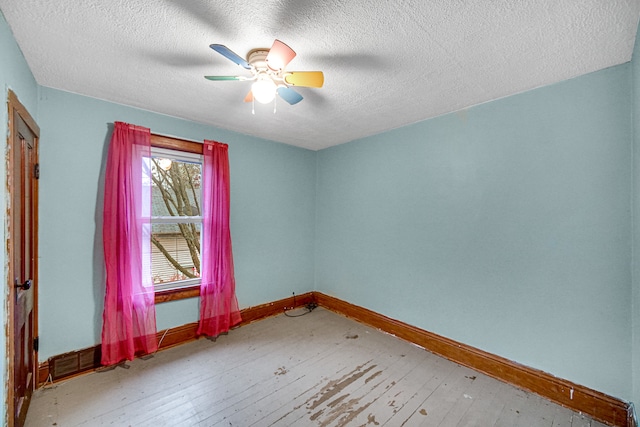 spare room with wood-type flooring, a textured ceiling, and ceiling fan