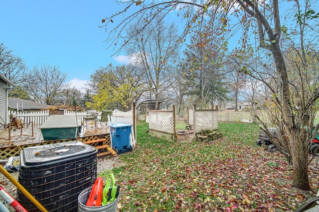 view of yard featuring central AC unit and a deck