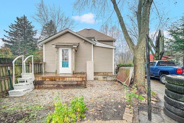 back of house featuring a wooden deck