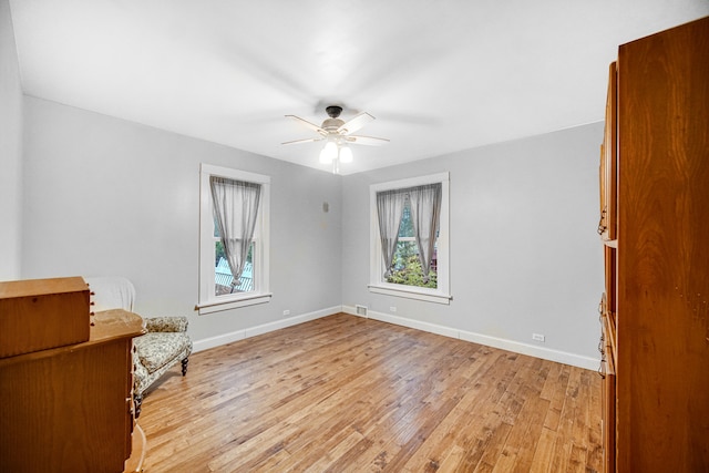 unfurnished room with ceiling fan and light hardwood / wood-style floors