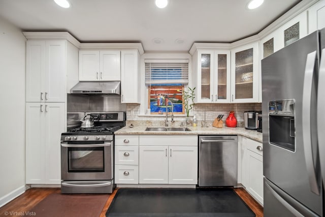 kitchen featuring sink, stainless steel appliances, ventilation hood, backsplash, and white cabinets