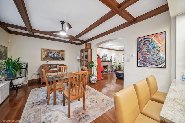 dining room with ceiling fan, dark hardwood / wood-style flooring, and coffered ceiling