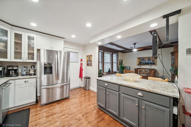 kitchen with ceiling fan, gray cabinets, light wood-type flooring, white cabinetry, and stainless steel appliances