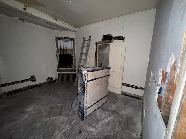 empty room featuring heating unit and radiator