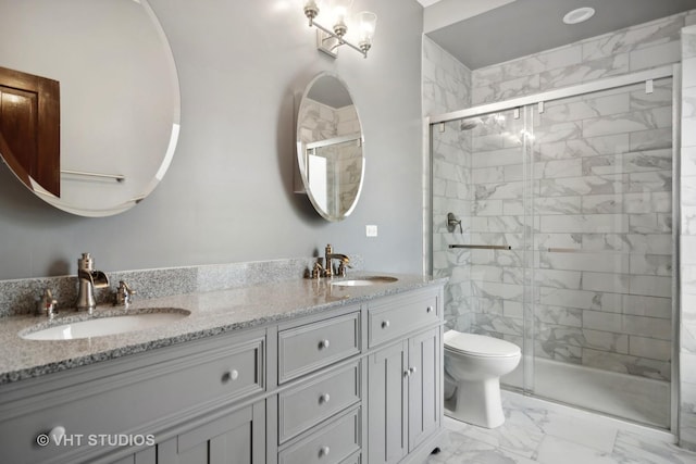 bathroom with vanity, toilet, and a shower with door