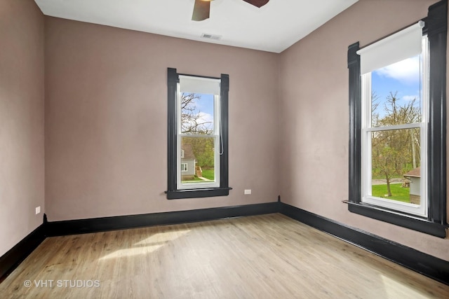 unfurnished room with ceiling fan and light wood-type flooring