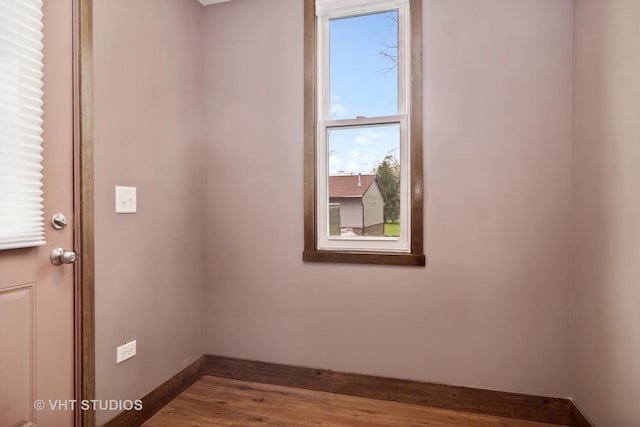 unfurnished room featuring hardwood / wood-style flooring and a wealth of natural light