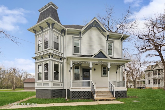 view of front of property with a porch and a front yard