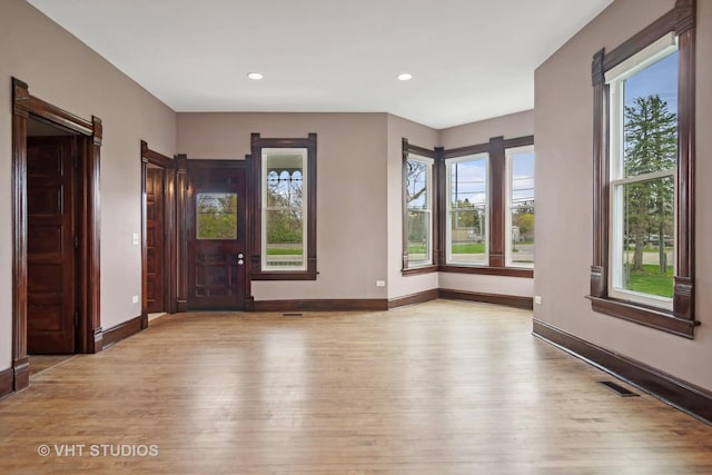 empty room featuring light hardwood / wood-style flooring and a healthy amount of sunlight