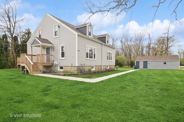 rear view of property with a wooden deck and a lawn