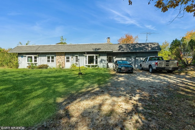ranch-style home with a chimney, board and batten siding, a front lawn, a garage, and driveway