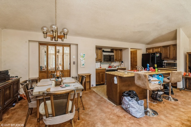 carpeted dining room with an inviting chandelier, a textured ceiling, and sink