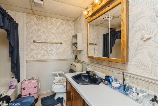 full bathroom featuring vanity, shower / bath combo with shower curtain, and toilet