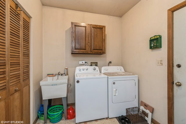 laundry room featuring separate washer and dryer and cabinets