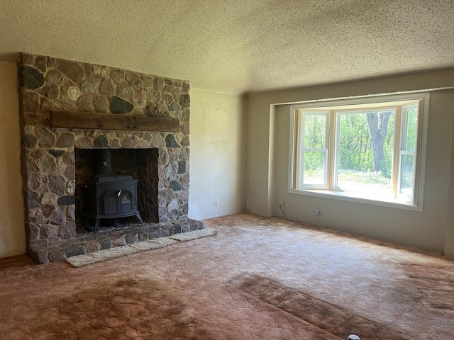 unfurnished living room featuring a wood stove, a textured ceiling, and carpet flooring