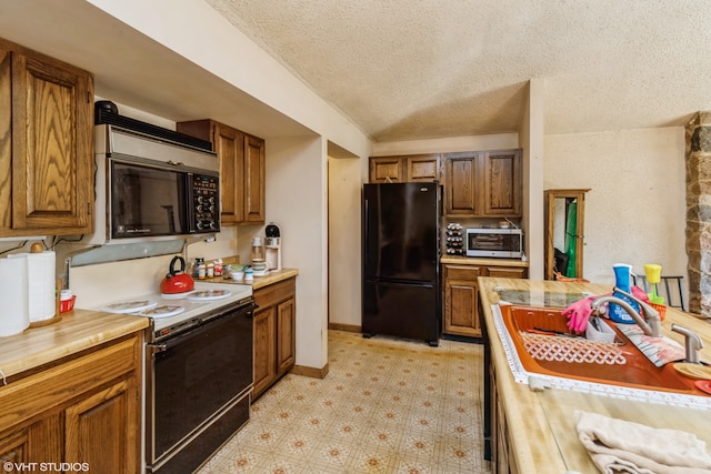 kitchen with sink, black appliances, a textured ceiling, and wooden counters