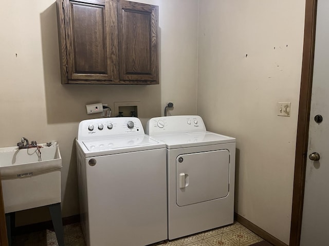 washroom featuring cabinet space, separate washer and dryer, and baseboards