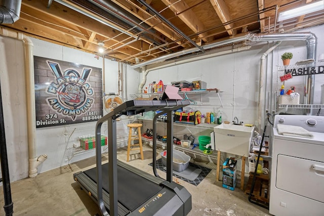 workout room with washer / dryer, concrete floors, and sink