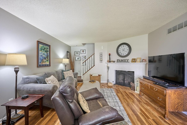 living room with hardwood / wood-style flooring and a textured ceiling