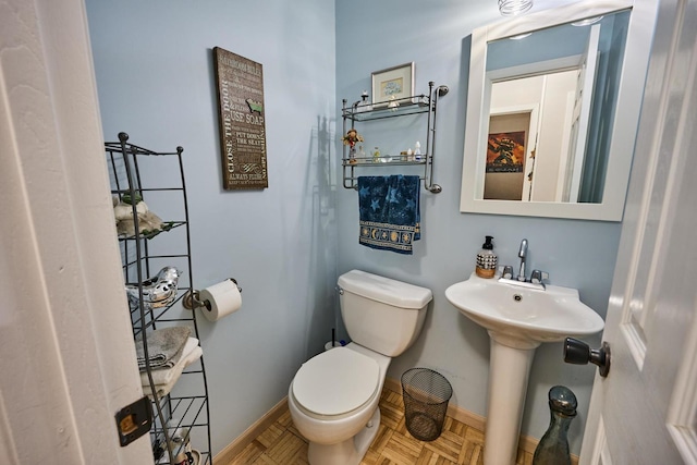 bathroom featuring toilet and parquet floors