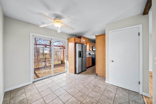 kitchen with ceiling fan, light tile patterned floors, and appliances with stainless steel finishes