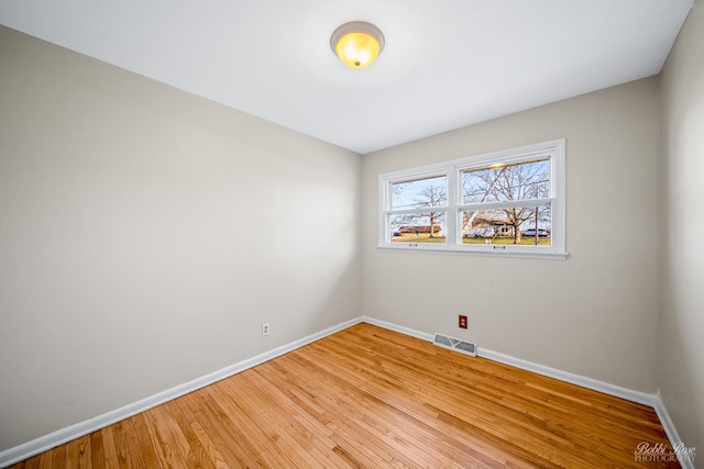 spare room with wood-type flooring