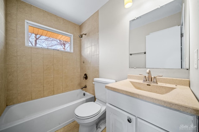 full bathroom with vanity, tiled shower / bath combo, and toilet