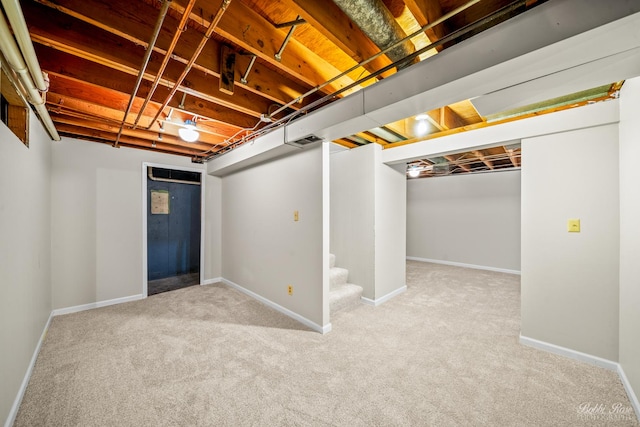 basement featuring light colored carpet