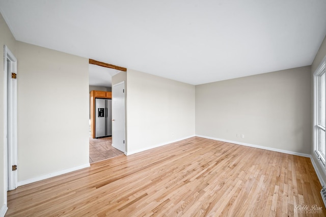 unfurnished room with light wood-type flooring