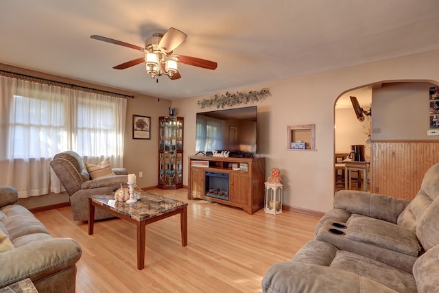 living room featuring light wood-type flooring and ceiling fan