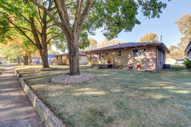 exterior space with a front yard and central AC unit