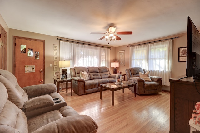 living room featuring light hardwood / wood-style flooring and ceiling fan