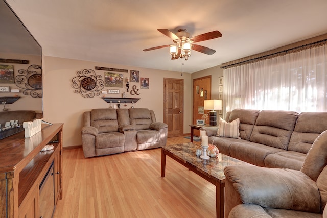 living room featuring light wood-type flooring and ceiling fan