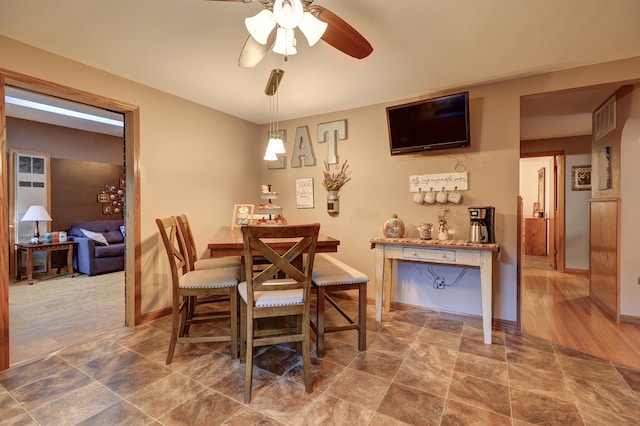 dining area featuring wood-type flooring and ceiling fan