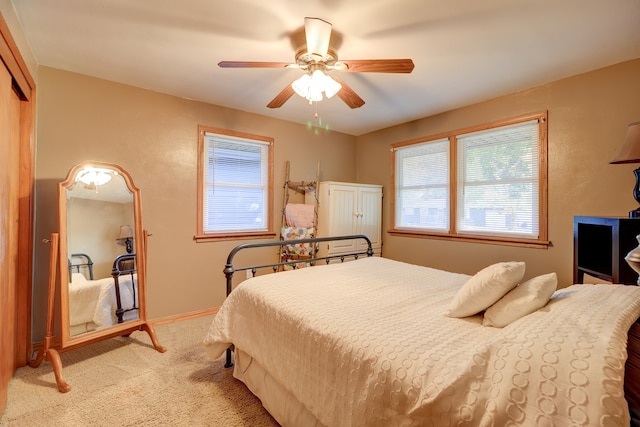 carpeted bedroom with a closet and ceiling fan