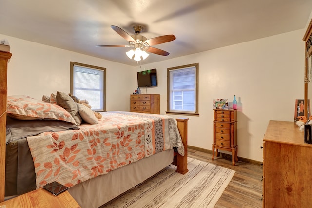 bedroom featuring hardwood / wood-style floors and ceiling fan