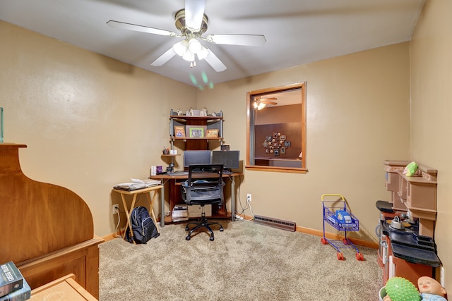 carpeted office space featuring ceiling fan