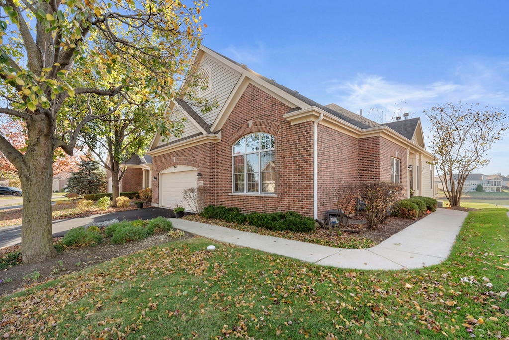 view of property exterior with a garage and a lawn