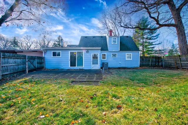 rear view of house featuring central air condition unit, a patio area, and a lawn