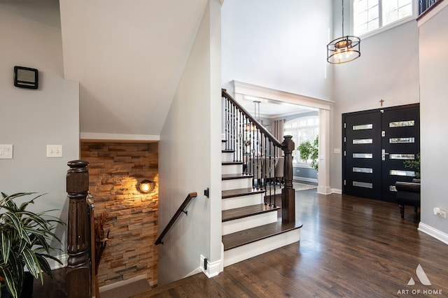 foyer entrance featuring a high ceiling and dark hardwood / wood-style floors