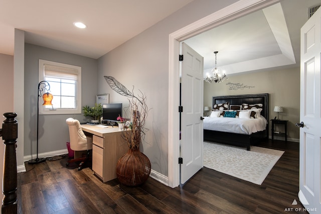 bedroom with a chandelier and dark hardwood / wood-style flooring