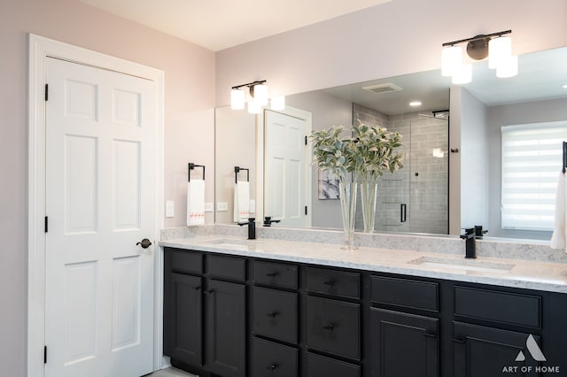 bathroom featuring vanity and a shower with shower door