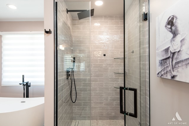 bathroom featuring shower with separate bathtub