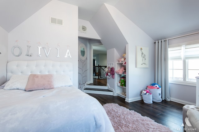 bedroom with dark wood-type flooring and vaulted ceiling