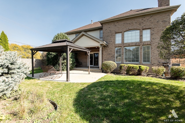 rear view of property with a patio and a yard