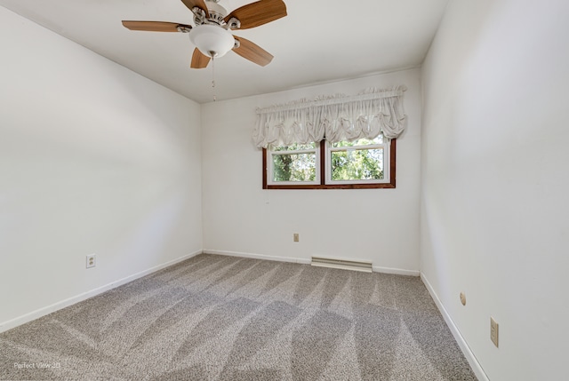 carpeted spare room featuring ceiling fan, visible vents, and baseboards