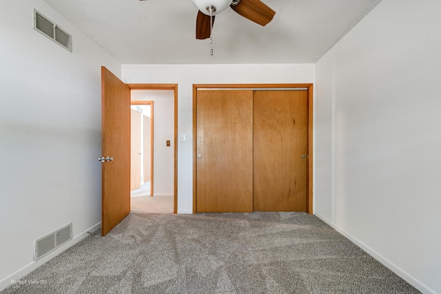 unfurnished bedroom featuring a ceiling fan, carpet, a closet, and visible vents